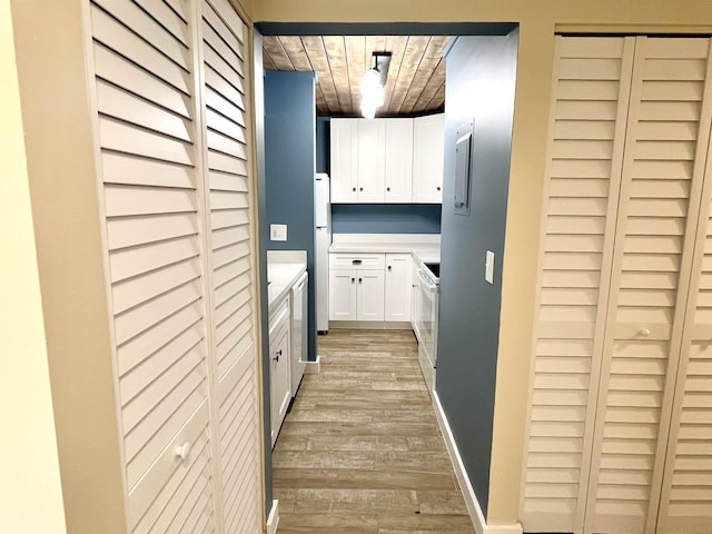 9 Alcira Ct, Saint Augustine, FL 32086 - kitchen with freestanding refrigerator, white cabinets, light countertops, and light wood-style flooring