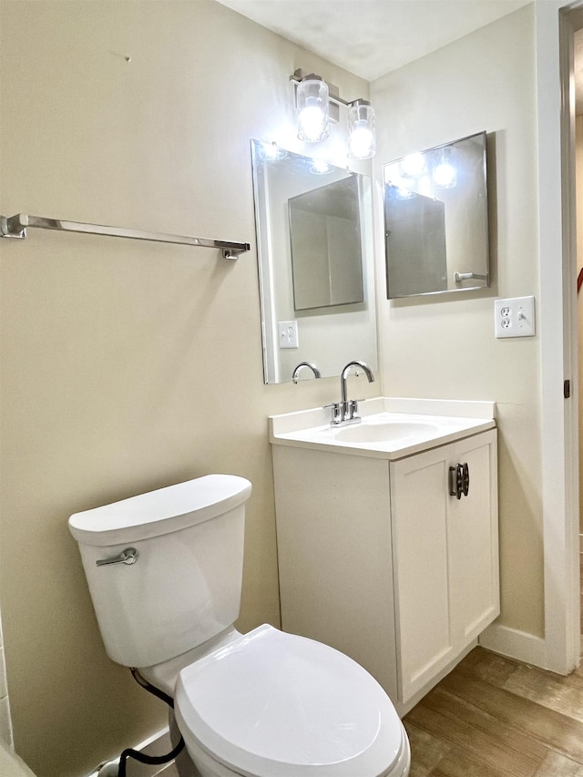 9 Alcira Ct, Saint Augustine, FL 32086 - bathroom featuring toilet, wood finished floors, baseboards, and vanity