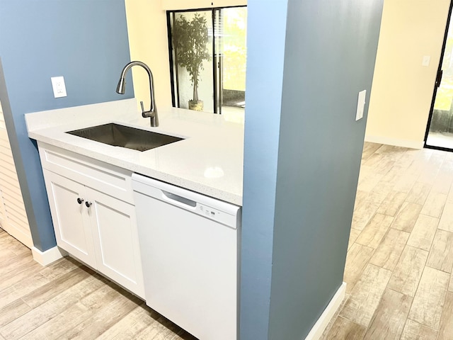 9 Alcira Ct, Saint Augustine, FL 32086 - kitchen with a sink, light countertops, white dishwasher, and light wood finished floors