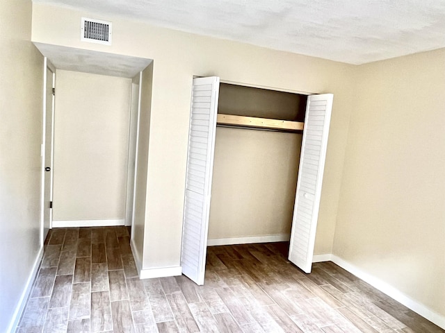 9 Alcira Ct, Saint Augustine, FL 32086 - unfurnished bedroom featuring baseboards, visible vents, a closet, and wood finished floors