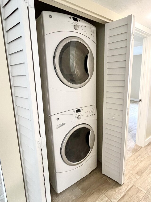9 Alcira Ct, Saint Augustine, FL 32086 - washroom with light wood-style floors, stacked washer / drying machine, and laundry area