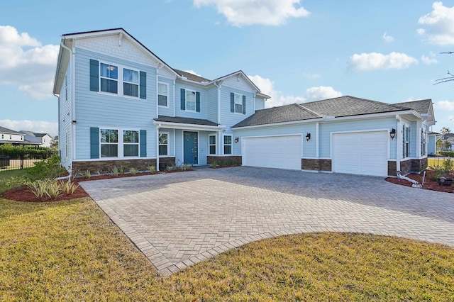 view of front of property with a garage and a front lawn