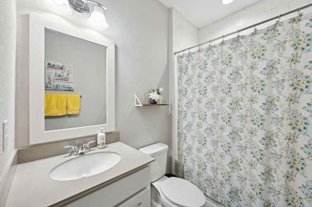 bathroom featuring a shower with curtain, vanity, and toilet