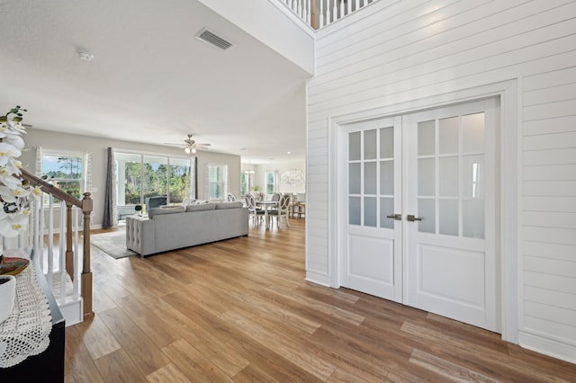 unfurnished living room featuring ceiling fan and light wood-type flooring