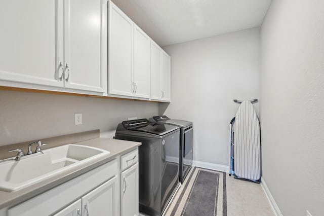 laundry area with sink, cabinets, and washing machine and clothes dryer