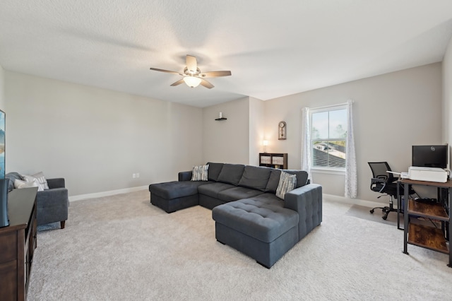 carpeted living room with ceiling fan and a textured ceiling