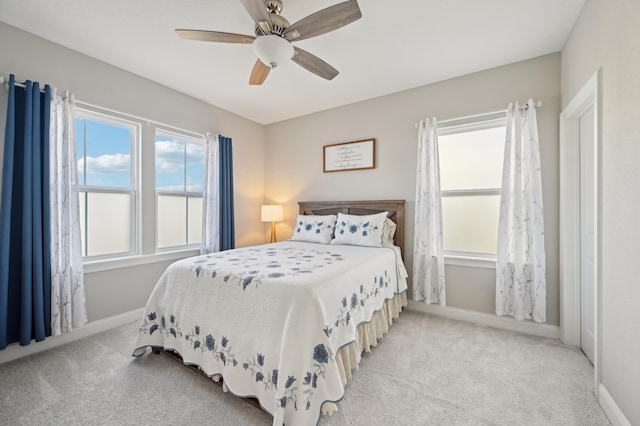 bedroom featuring light colored carpet and ceiling fan