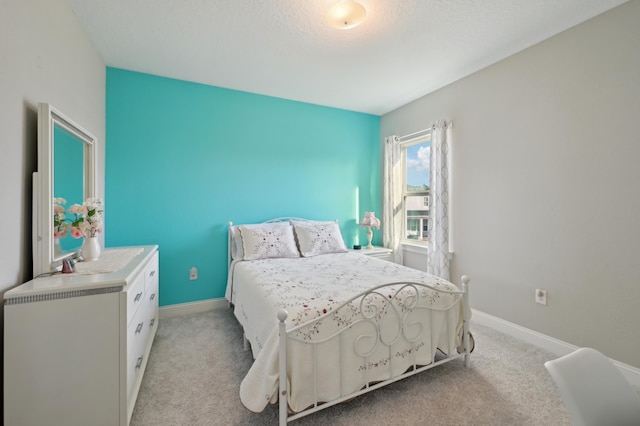 carpeted bedroom featuring a textured ceiling