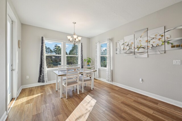 dining room featuring a chandelier and light wood-type flooring