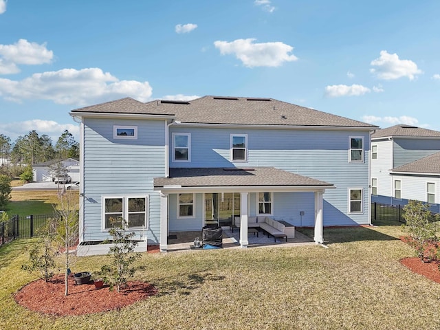 rear view of house with outdoor lounge area, a yard, and a patio area