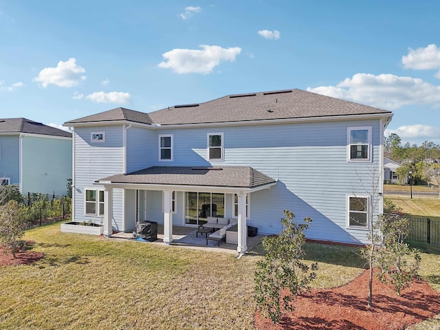 rear view of property featuring a patio area and a lawn