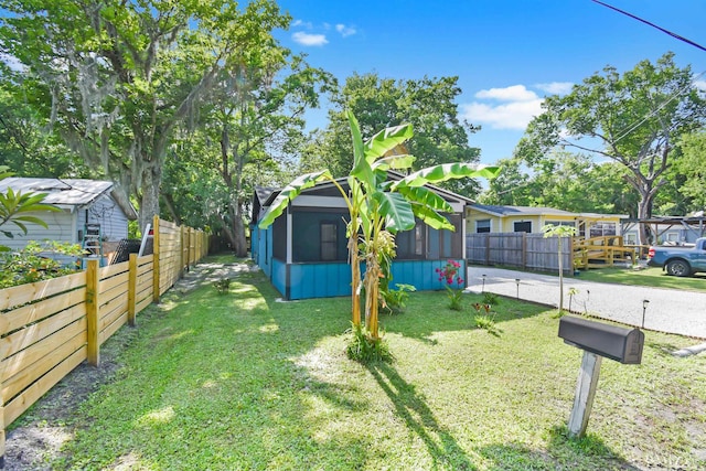view of yard featuring a sunroom