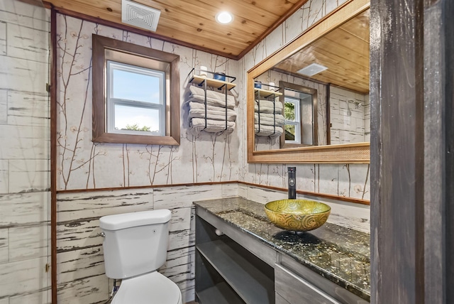 half bath featuring wood ceiling, vanity, toilet, plenty of natural light, and recessed lighting