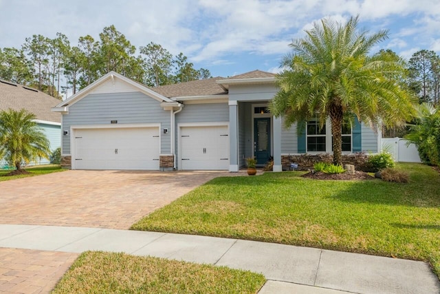 view of front of property with a garage and a front yard