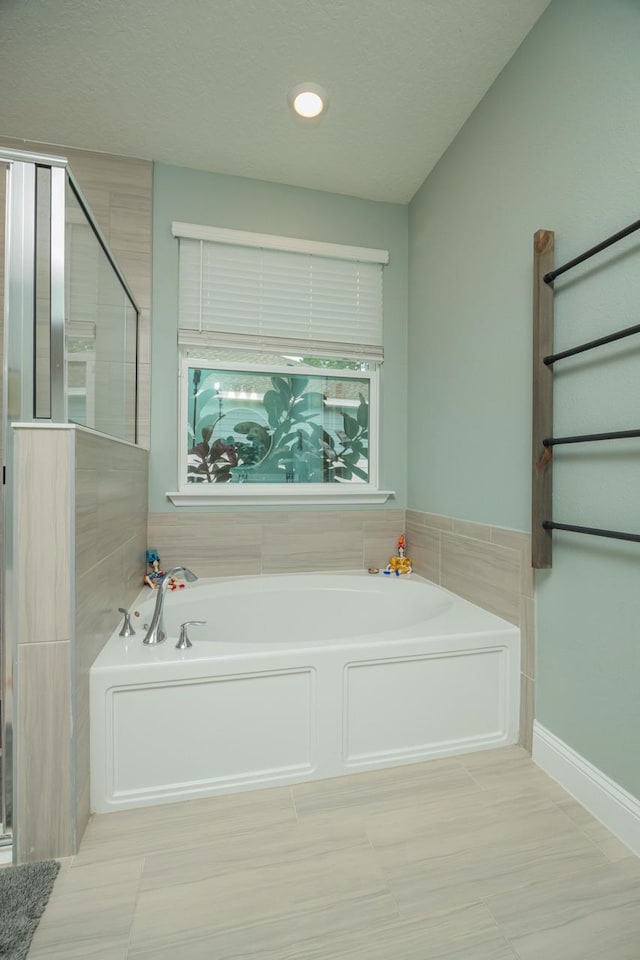 bathroom featuring separate shower and tub