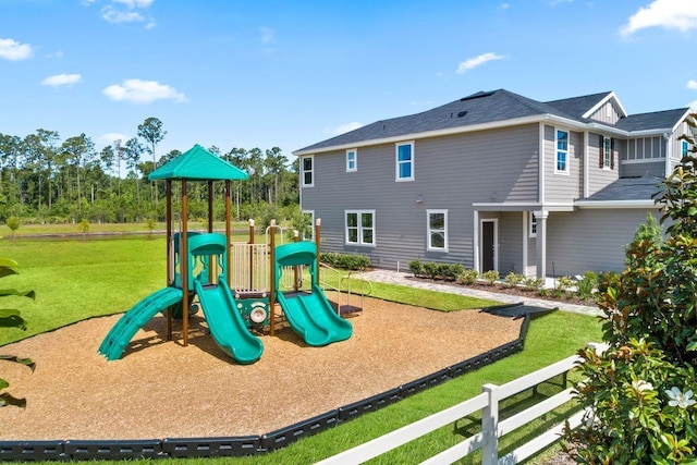 view of playground with a lawn