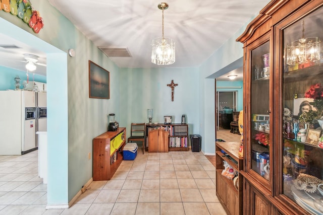 dining space featuring a chandelier, visible vents, baseboards, and light tile patterned floors