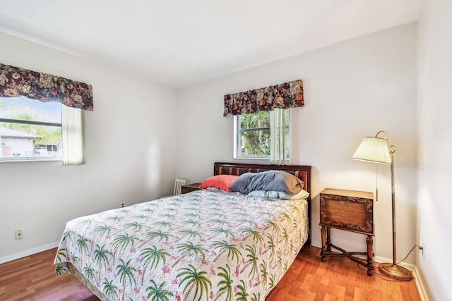 bedroom with wood finished floors and baseboards