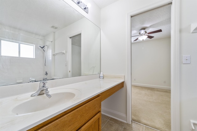 bathroom with tile patterned flooring, visible vents, vanity, a textured ceiling, and a ceiling fan