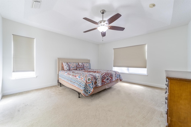 bedroom with visible vents, carpet floors, baseboards, and ceiling fan