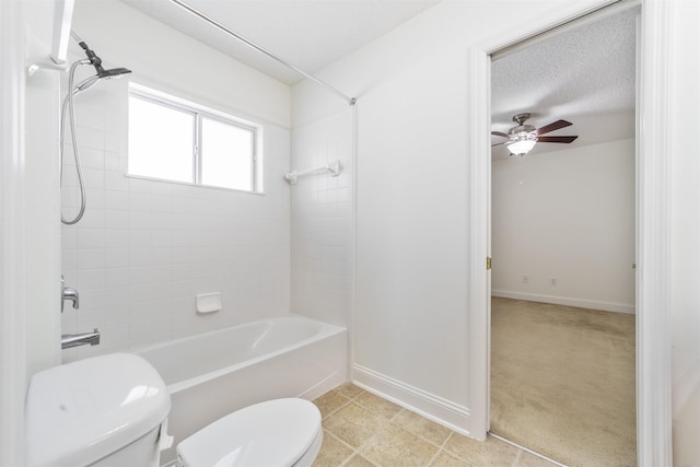 full bath featuring a ceiling fan, baseboards, toilet, a textured ceiling, and  shower combination