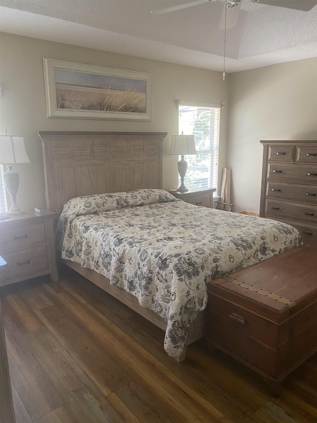 bedroom with dark wood-style flooring and a textured ceiling