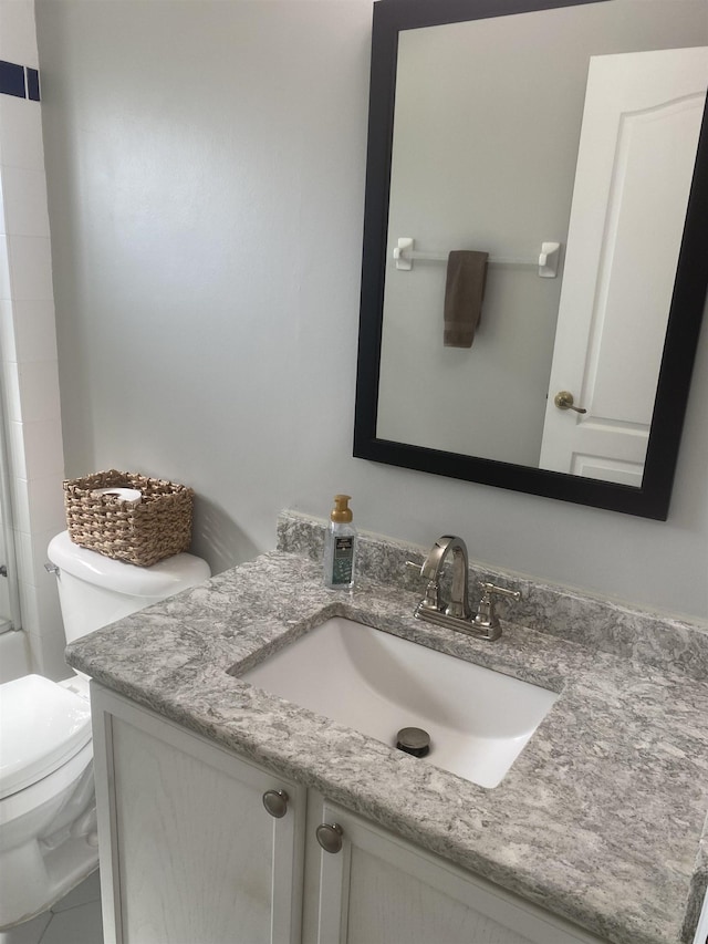 bathroom featuring a shower, toilet, and vanity