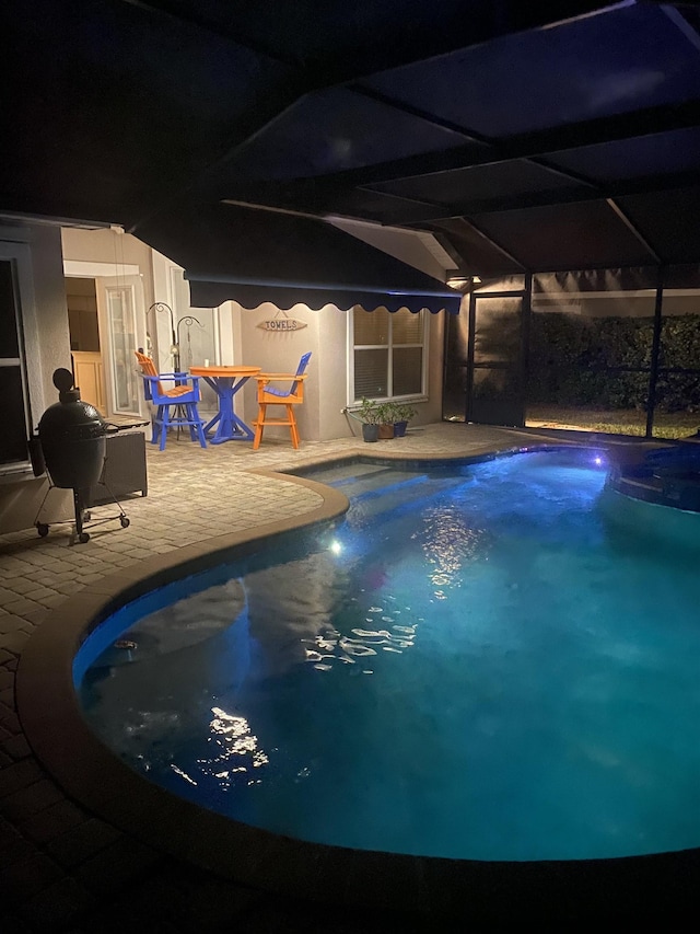 outdoor pool featuring a lanai and a patio area