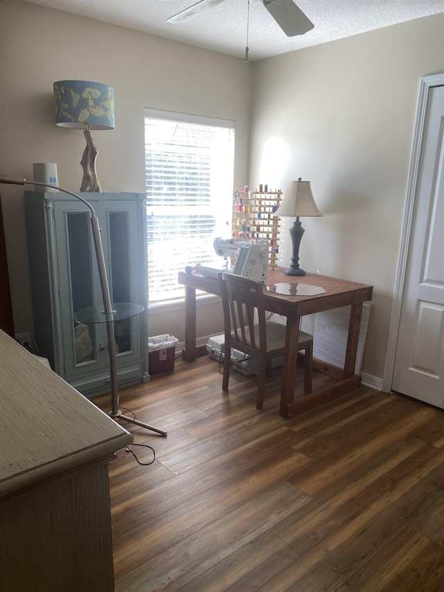 office with a textured ceiling, baseboards, a ceiling fan, and dark wood-style flooring