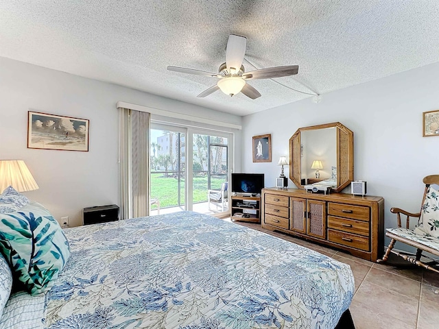 tiled bedroom with ceiling fan, a textured ceiling, and access to outside