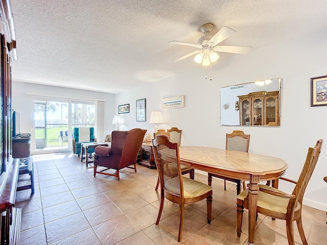 tiled dining room with ceiling fan and a textured ceiling