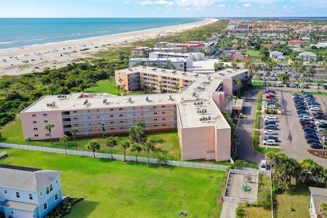 birds eye view of property featuring a water view and a beach view