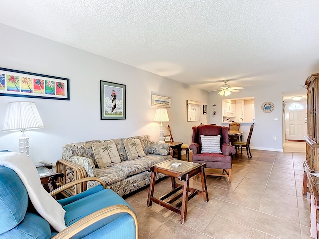 tiled living room with ceiling fan and a textured ceiling