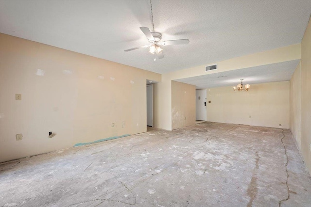 spare room featuring a textured ceiling and ceiling fan with notable chandelier