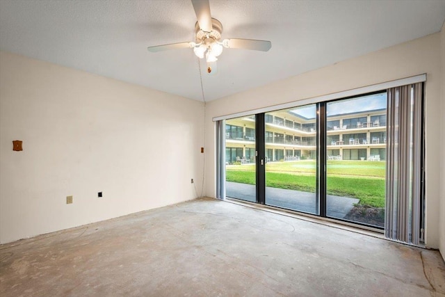 unfurnished room with ceiling fan, plenty of natural light, and a textured ceiling