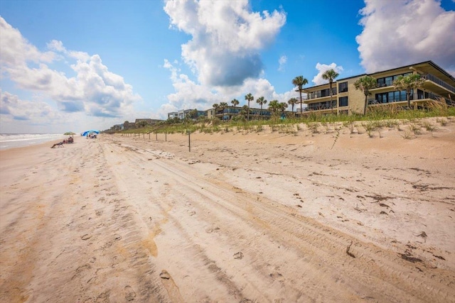 exterior space featuring a water view and a view of the beach