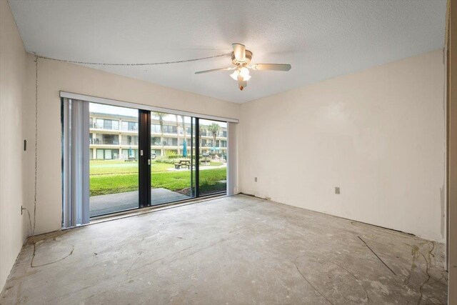 empty room featuring ceiling fan and a textured ceiling