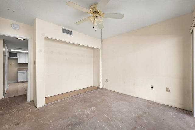 interior space with ceiling fan, concrete floors, and a closet