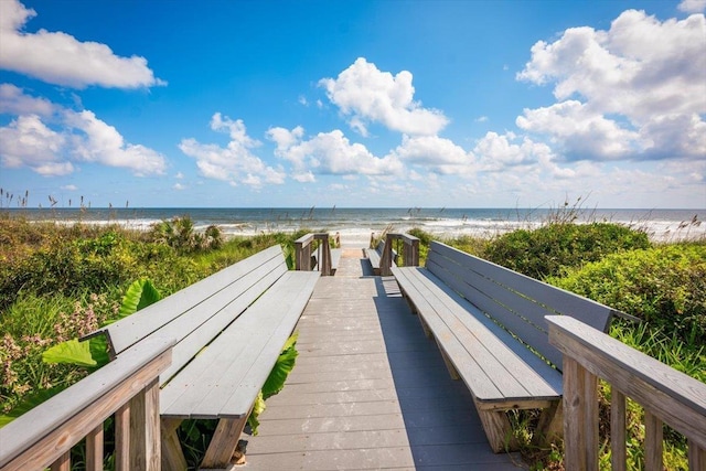 view of property's community with a view of the beach and a water view