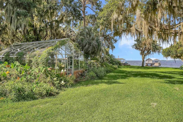 6433 Jack Wright Island Rd, Saint Augustine, FL 32092 - view of grassy yard featuring a greenhouse, a water view, and an outdoor structure
