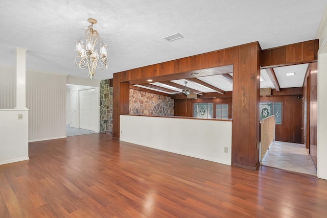 6433 Jack Wright Island Rd, Saint Augustine, FL 32092 - unfurnished living room with wood finished floors, a chandelier, wooden walls, and beam ceiling