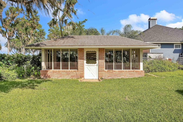 6433 Jack Wright Island Rd, Saint Augustine, FL 32092 - rear view of house featuring brick siding, a yard, a shingled roof, and a chimney