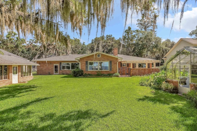 6433 Jack Wright Island Rd, Saint Augustine, FL 32092 - back of property featuring a chimney, a lawn, an exterior structure, and brick siding