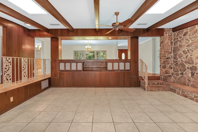 6433 Jack Wright Island Rd, Saint Augustine, FL 32092 - spare room featuring beamed ceiling, a ceiling fan, a chandelier, wooden walls, and light tile patterned flooring