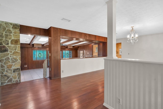6433 Jack Wright Island Rd, Saint Augustine, FL 32092 - unfurnished living room featuring wood finished floors, wooden walls, and a chandelier