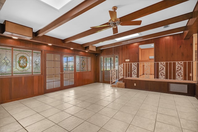 6433 Jack Wright Island Rd, Saint Augustine, FL 32092 - unfurnished room with beamed ceiling, wooden walls, french doors, tile patterned flooring, and ceiling fan