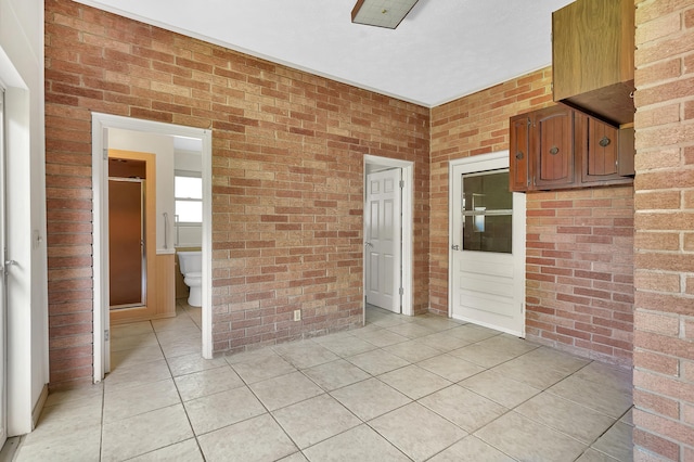 6433 Jack Wright Island Rd, Saint Augustine, FL 32092 - unfurnished room with brick wall and light tile patterned flooring