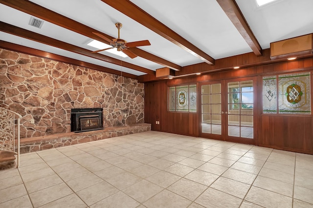 6433 Jack Wright Island Rd, Saint Augustine, FL 32092 - unfurnished living room with beamed ceiling, tile patterned floors, a ceiling fan, a fireplace, and french doors