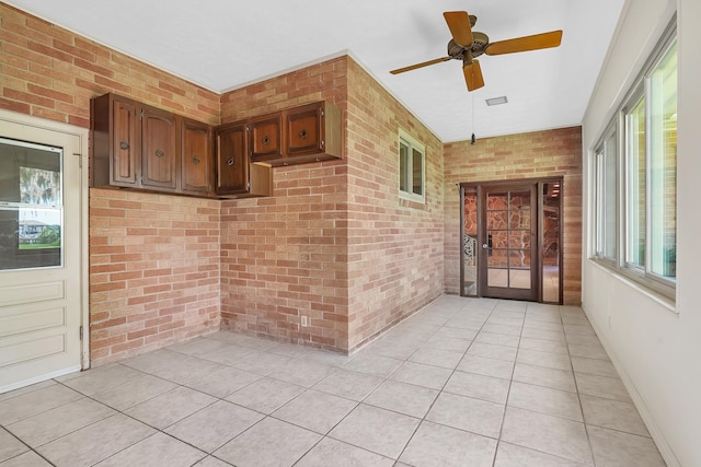 6433 Jack Wright Island Rd, Saint Augustine, FL 32092 - unfurnished sunroom with brick wall and tile patterned flooring