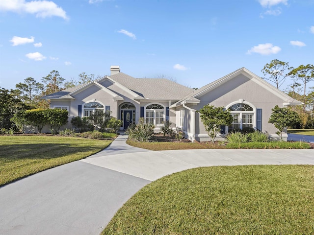 ranch-style house featuring a front lawn